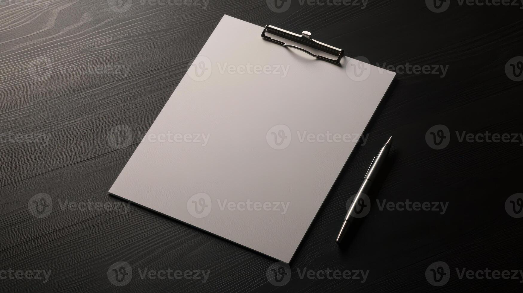 Blank clipboard with pen on black table photo