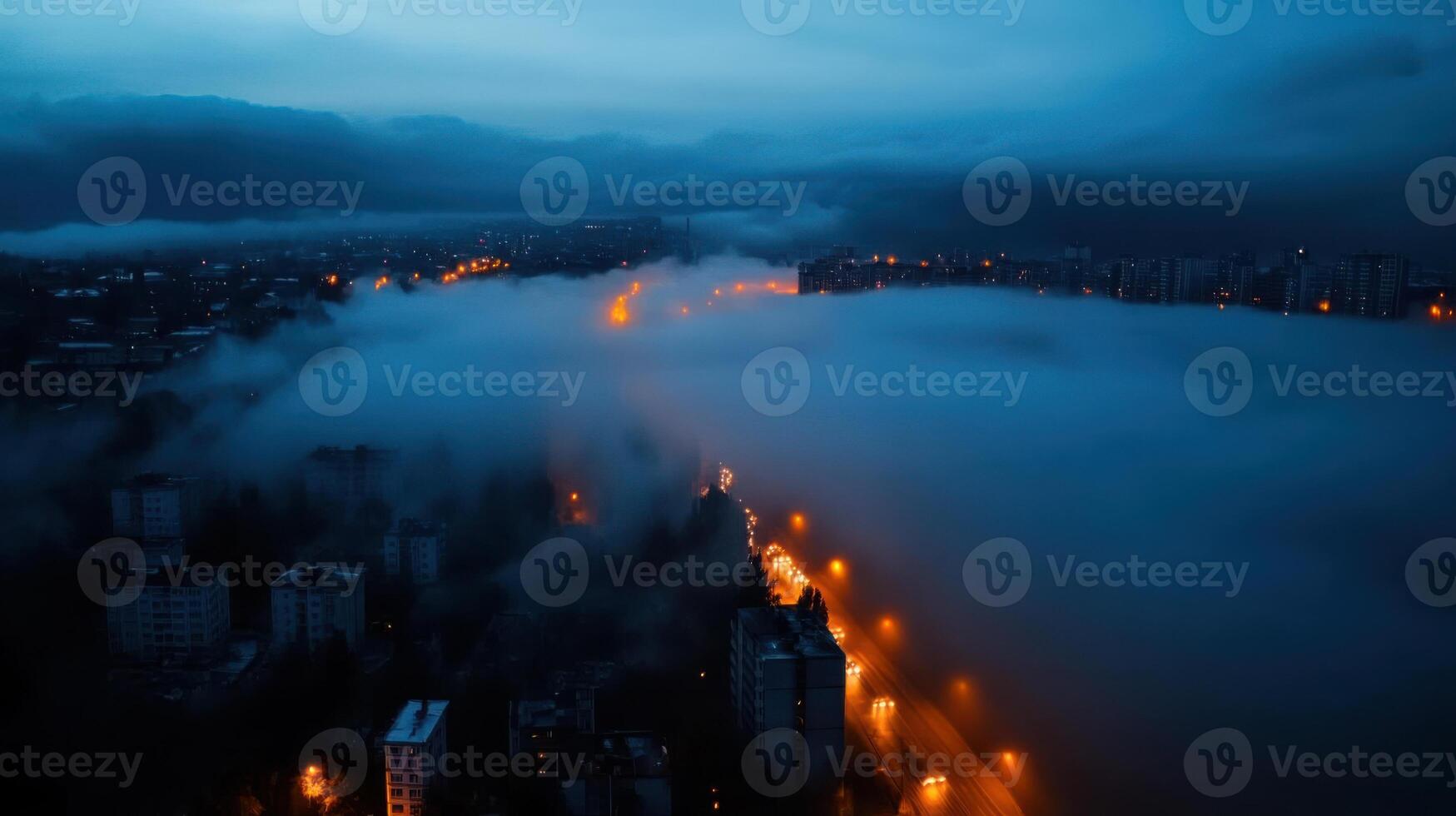 A city street is seen in the fog at night photo