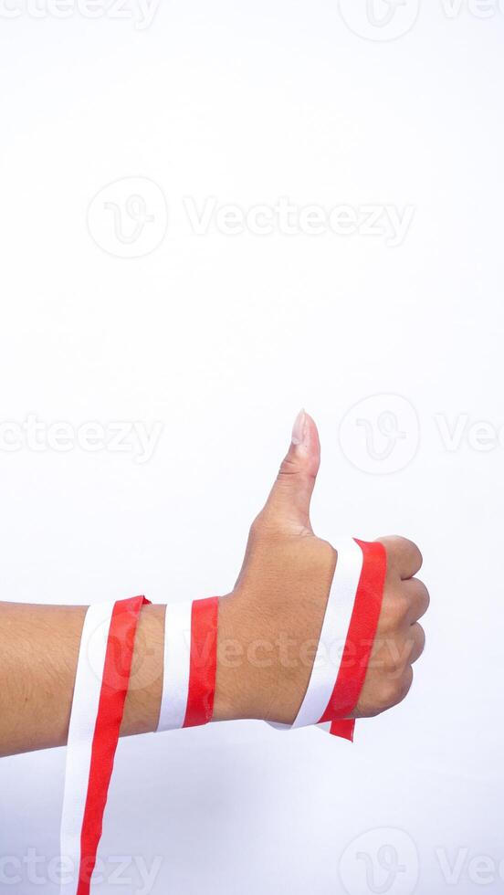 Man's Hands Wrap Around with Red and White Ribbons Showing Thumb Up on White Background photo