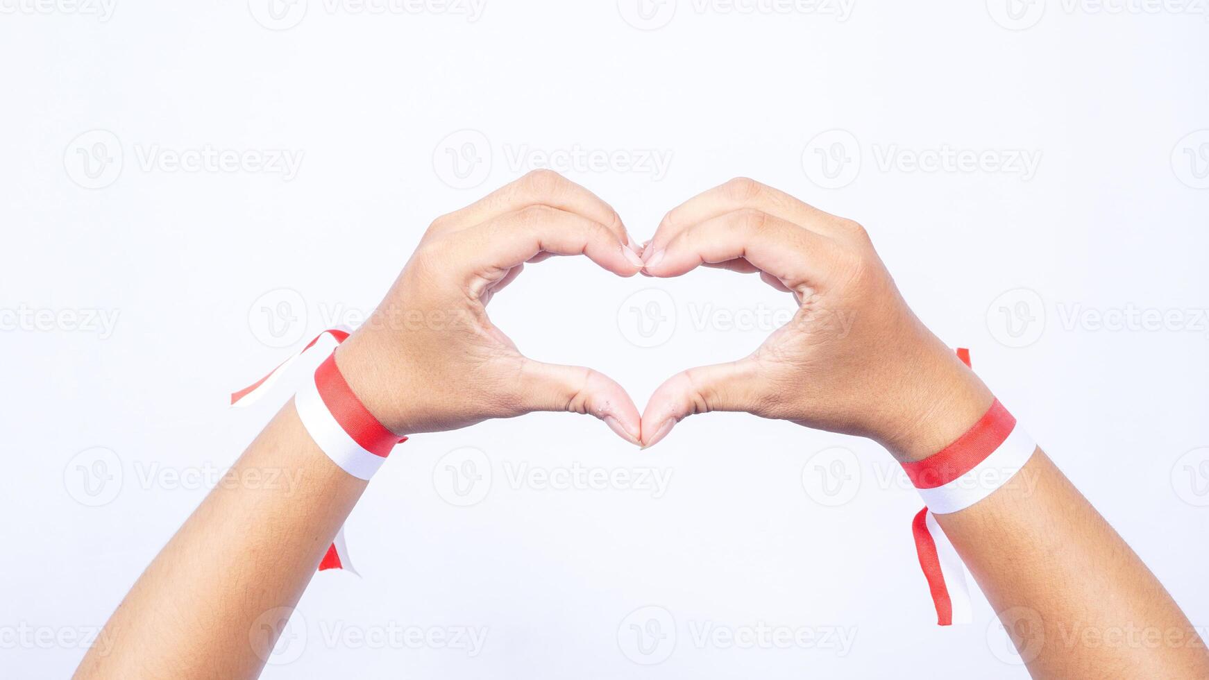 Hands with Red and White Ribbons Showing Love Sign on White Background photo