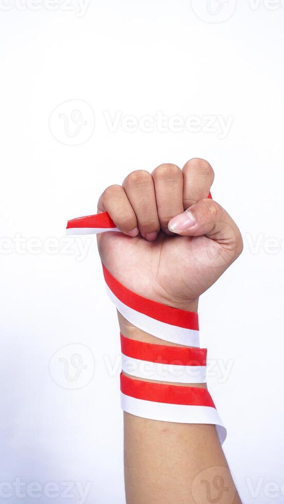 Clenched Fist with Red and White Ribbons Wrapped Around The Hand on White Background photo