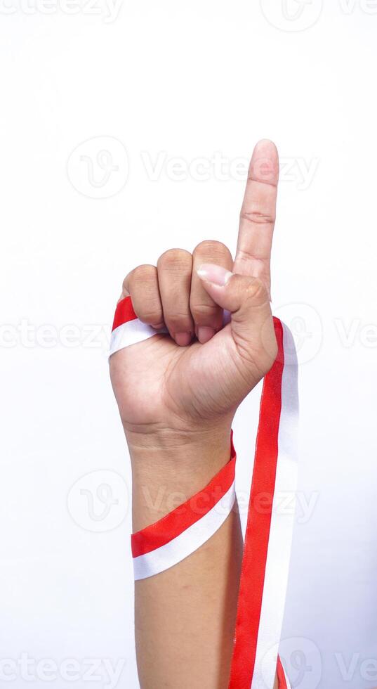 Hand with Red and White Ribbons Showing Number One Sign on White Background photo