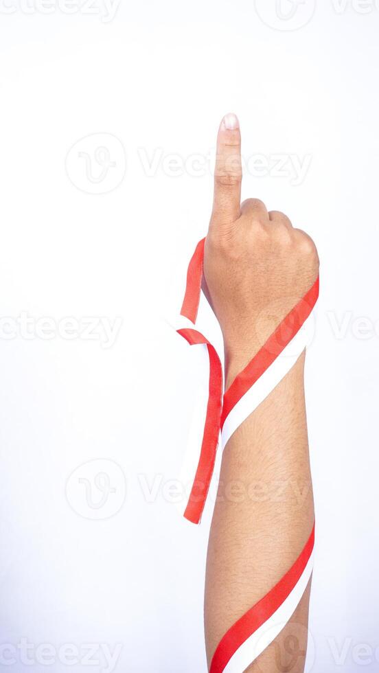 Man's Hand with Red and White Ribbons Showing Number One Sign on White Background photo