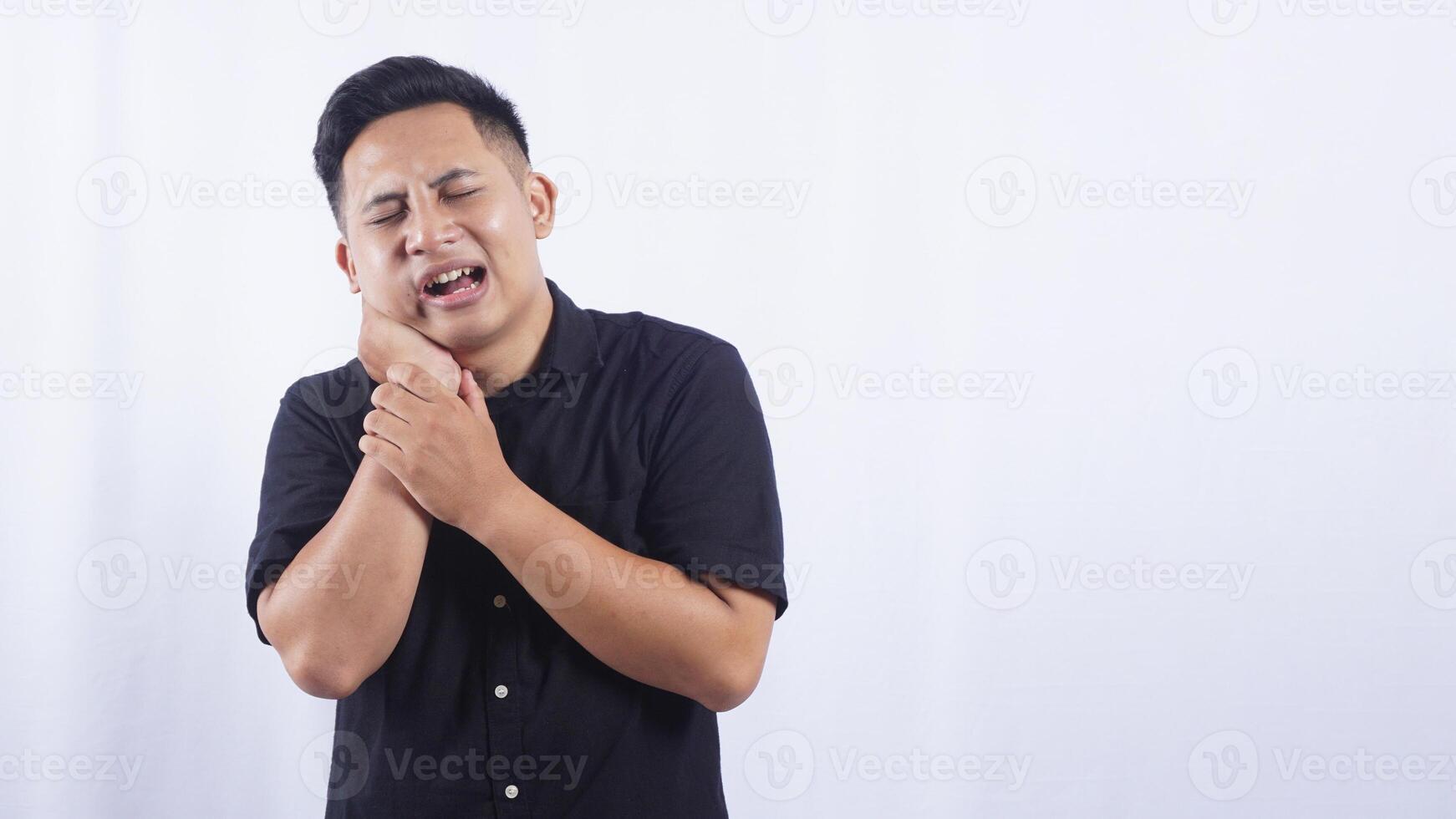 Asian Man with Swollen Cheek Suffering from Toothache on White Background photo