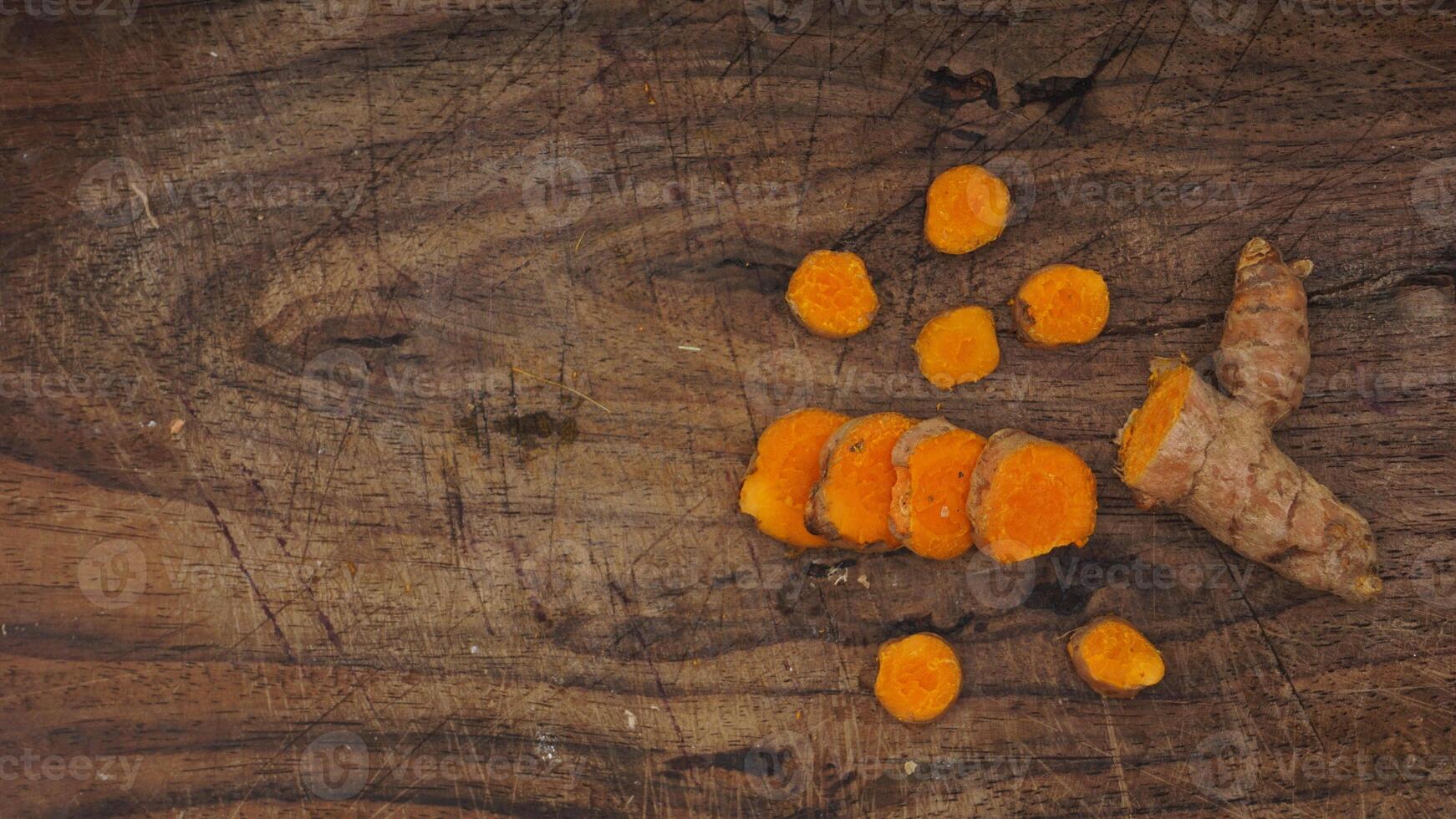Turmeric Spice on Wooden Cutting Board Background photo