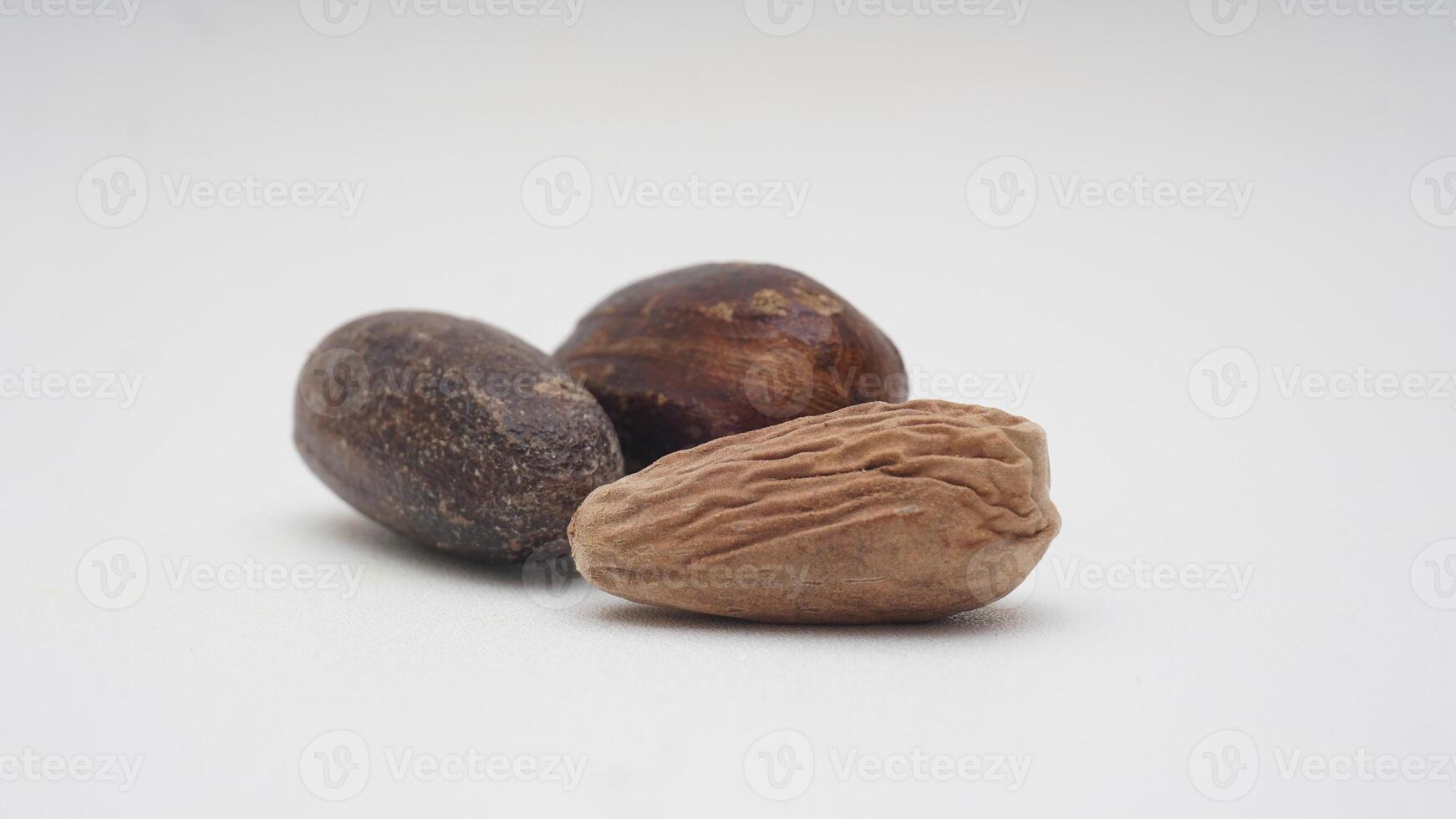 Whole Nutmegs with Nutmeg Seed on White Background photo