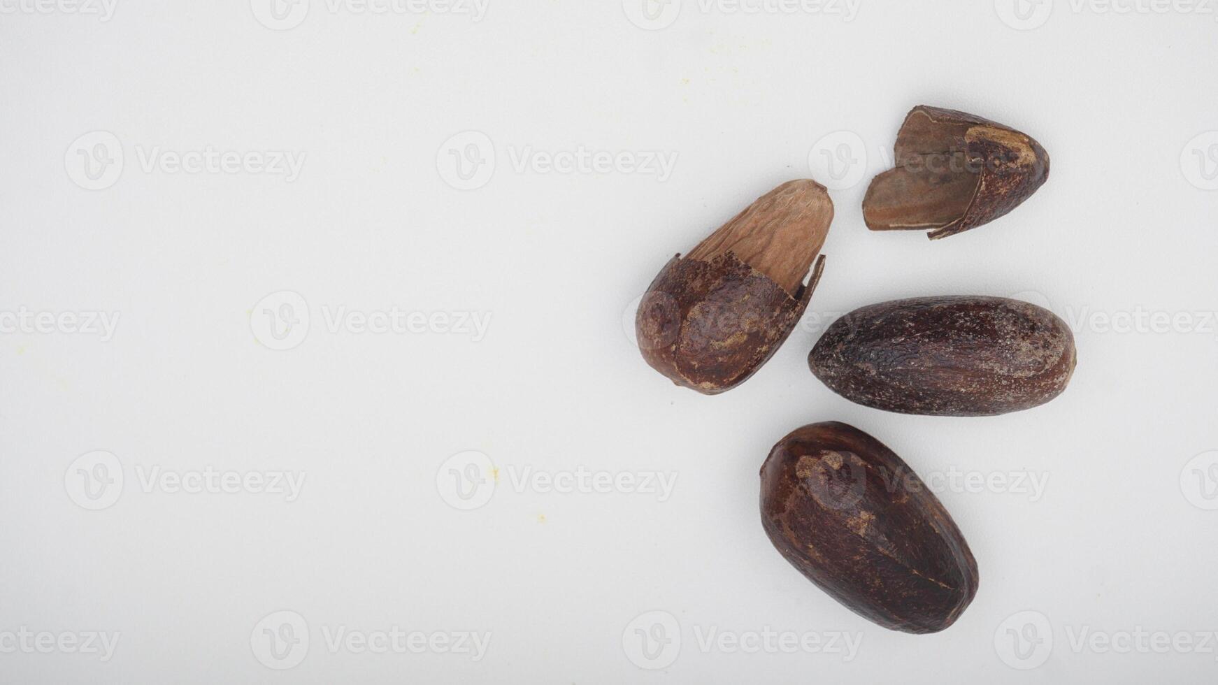 Top View of Whole Nutmeg and Nutmeg with Broken Skin on White Background photo