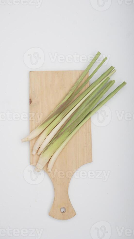 Lemongrass on Wooden Cutting Board on White Background photo