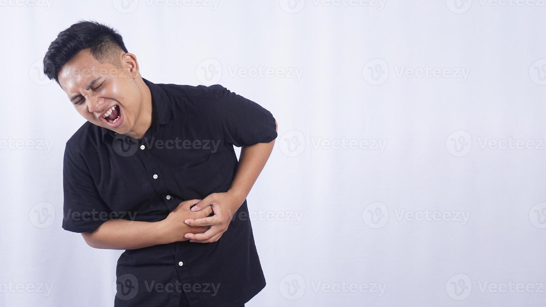 Asian Man with Stomach Pain on White Background photo