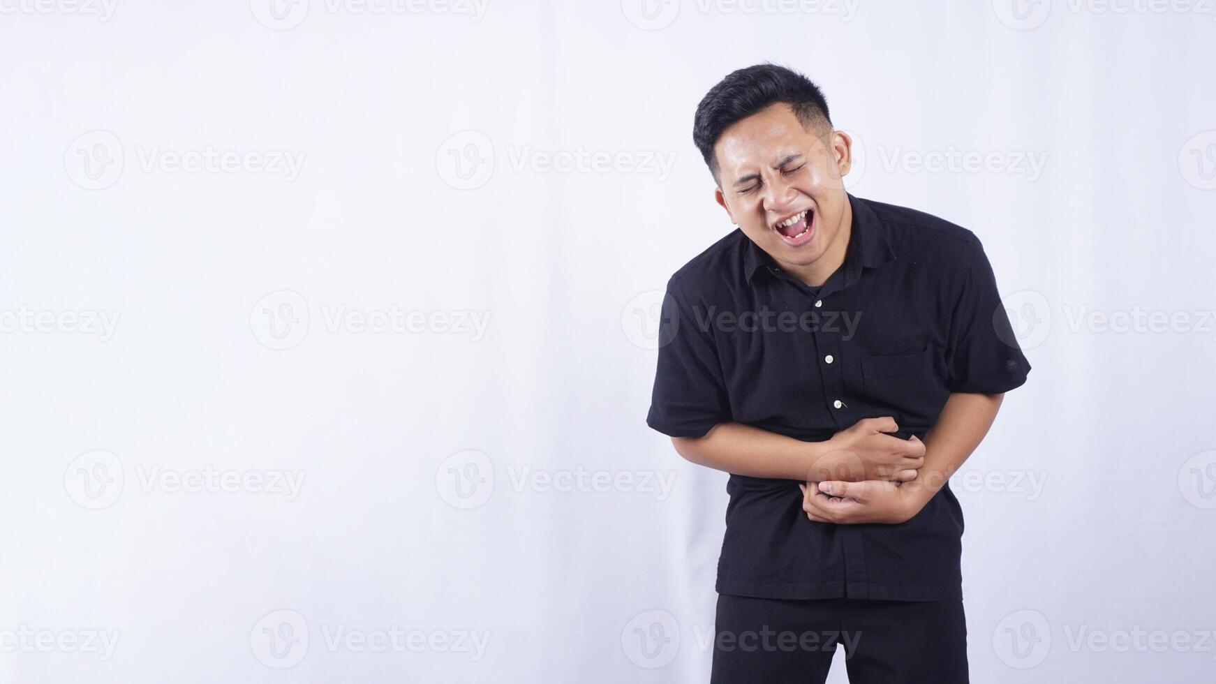 Sick Asian Man with Abdominal Pain on White Background photo