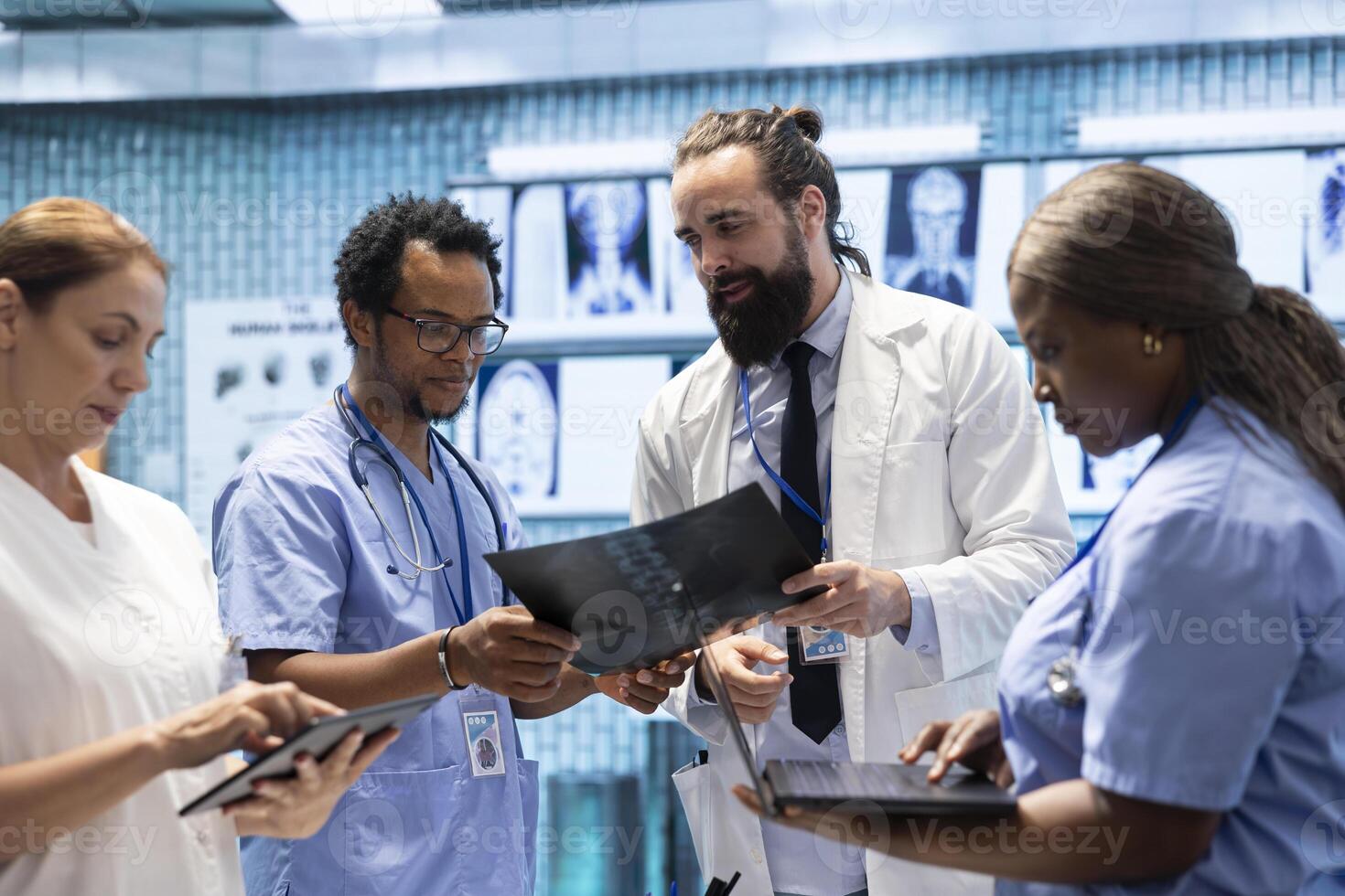 General practitioner collaborates with his staff about test results and treatment options, teamwork. Physician with expertise consulting and radiography supports disease prevention in a facility. photo
