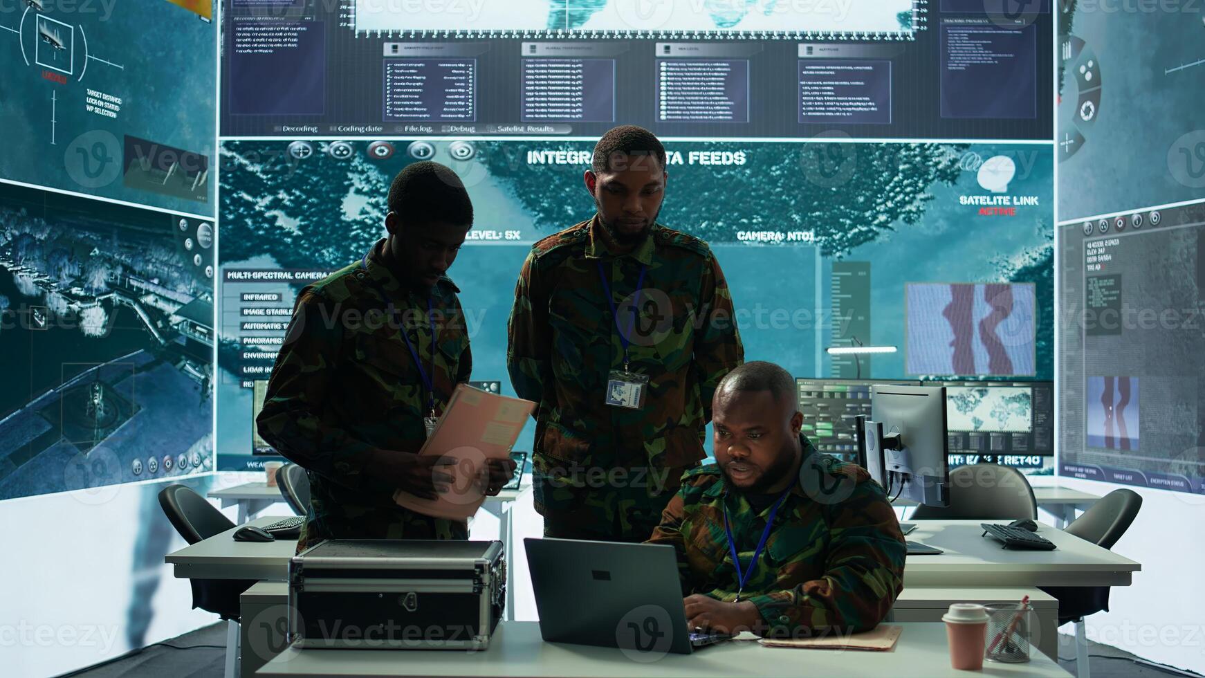 Military personnel in a modern command center handle critical information, collecting live surveillance data to maintain security protocols. Team of army crew working on reconnaissance. Camera B. photo