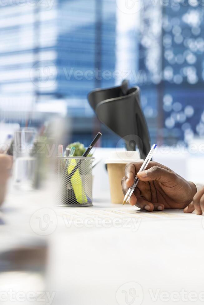 HR worker reviewing candidate, asking questions about qualifications, giving him application form. Close up of applicant writing signature on paperwork after proving enthusiasm for job opportunity photo