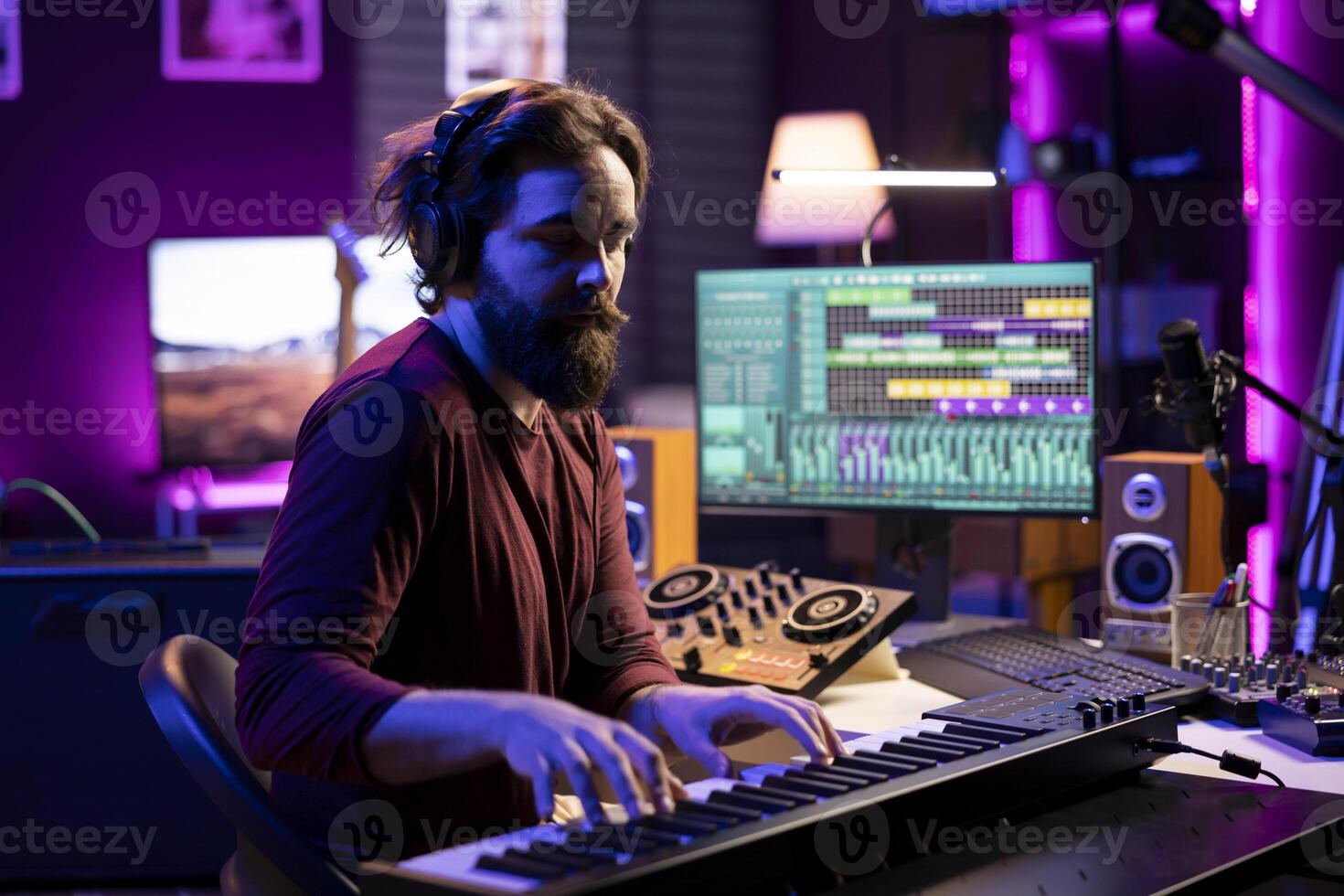 Skilled musician artist playing piano synthesizer notes for audio recording session, working in musical post production. Talented singer editing songs and adding sound effects in home studio. photo