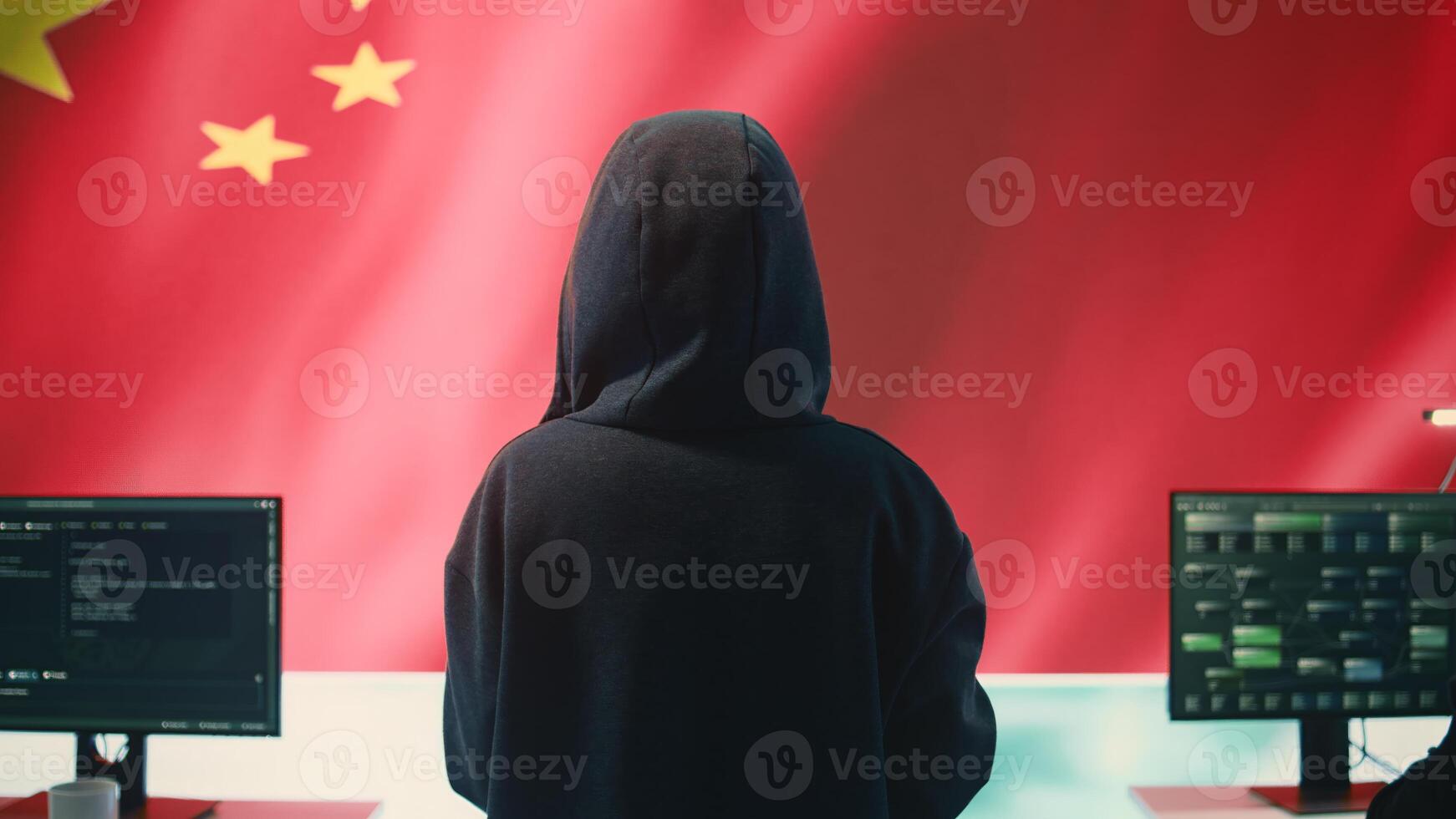 Governmental hacker in high tech office with Chinese flag shown on big screen, IT expert engaged in cyber espionage and criminal activity. Spreading fake news and brainwashing the nation. Camera B. photo