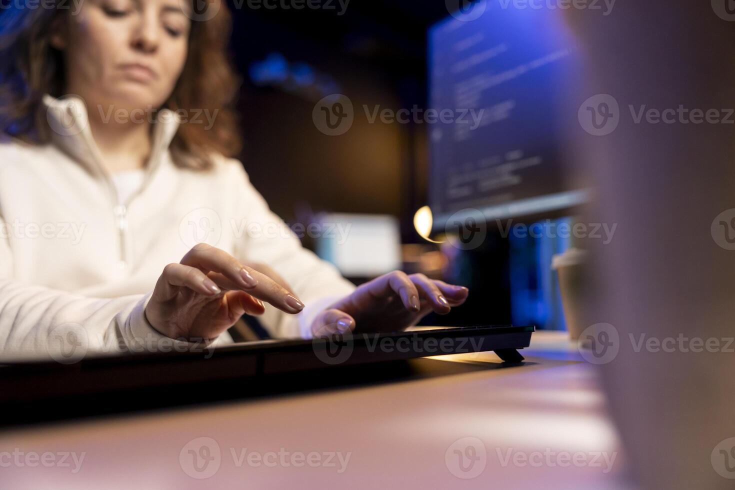 Teleworking programmer doing software debugging, checking flaws in lines of code displayed on PC monitors. IT admin in apartment fixing coding issues, typing on PC keyboard photo