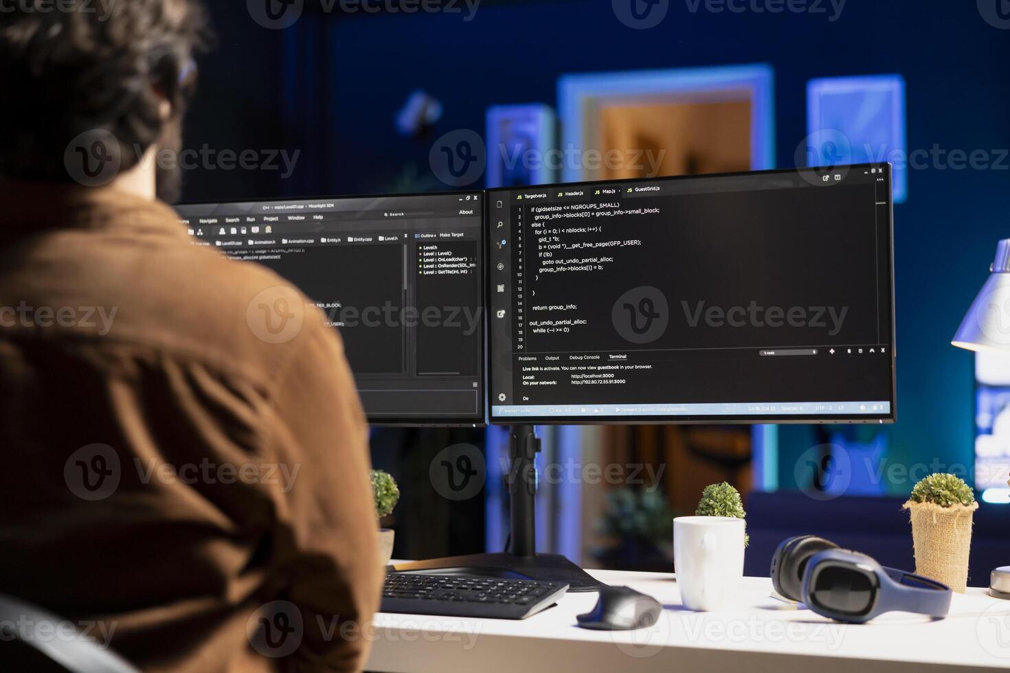 Man working from home implementing security measures to protect company systems and data. Tech support IT worker writing, testing and debugging code for software applications photo