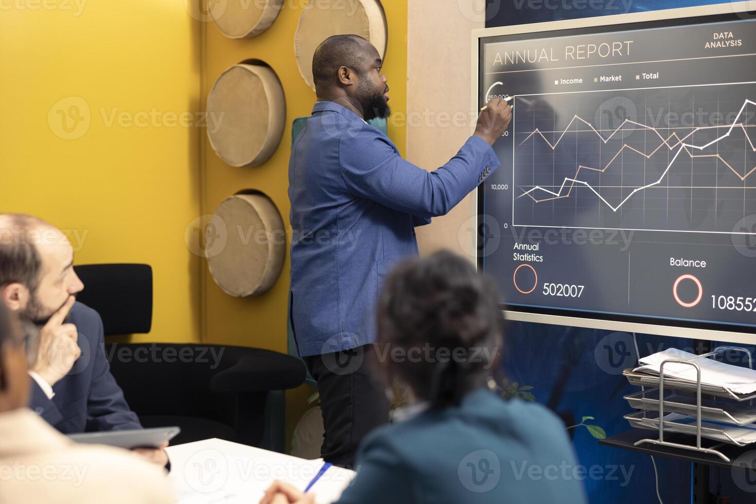 Marketing and PR group meeting to review infographics in conference room, sharing insight for corporation branding and development strategies. Build and maintain a better public image. photo