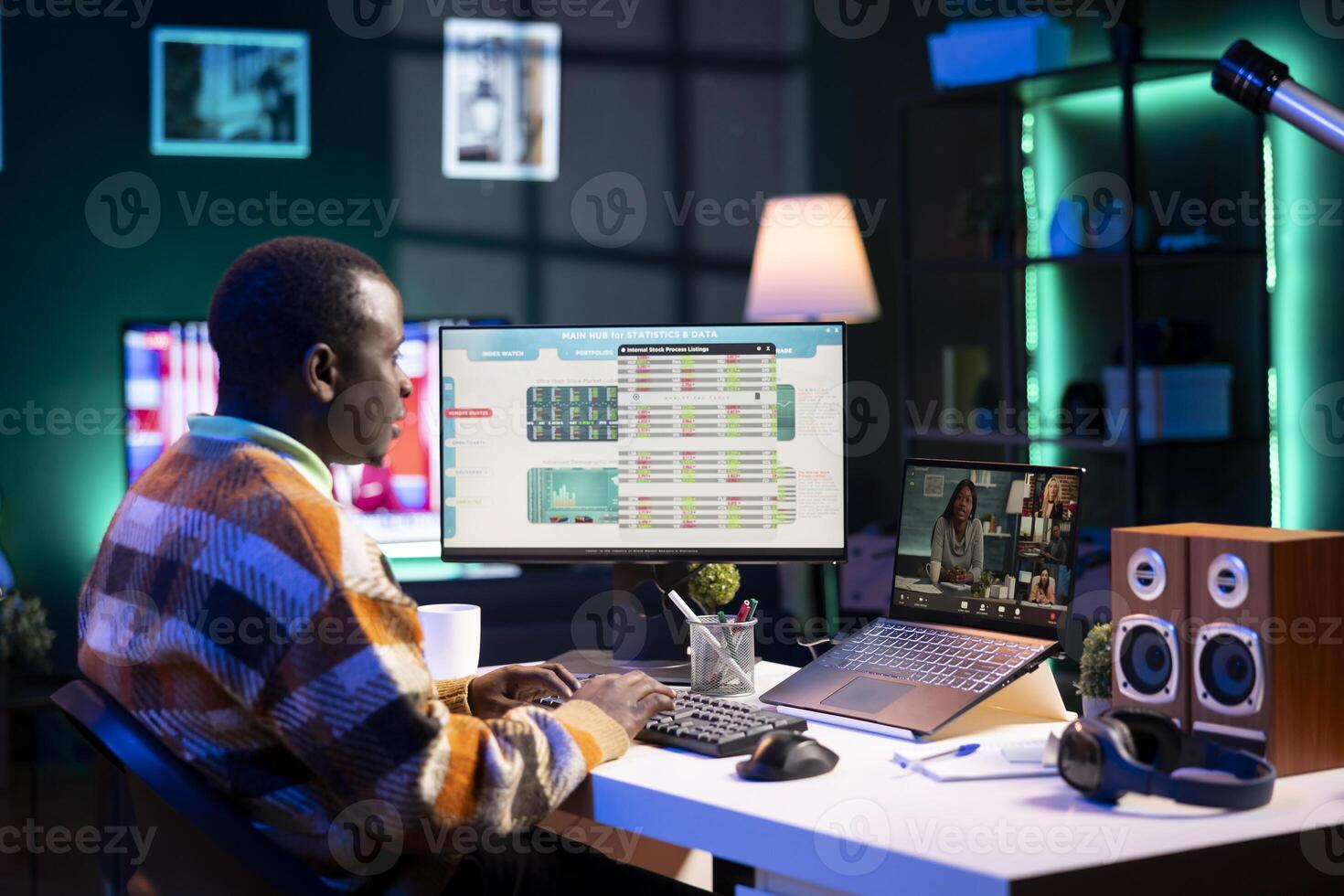 African American man having discussion during online meeting on laptop, talking about internet statistics or data. Male freelancer use technology for virtual communication, working remotely. photo