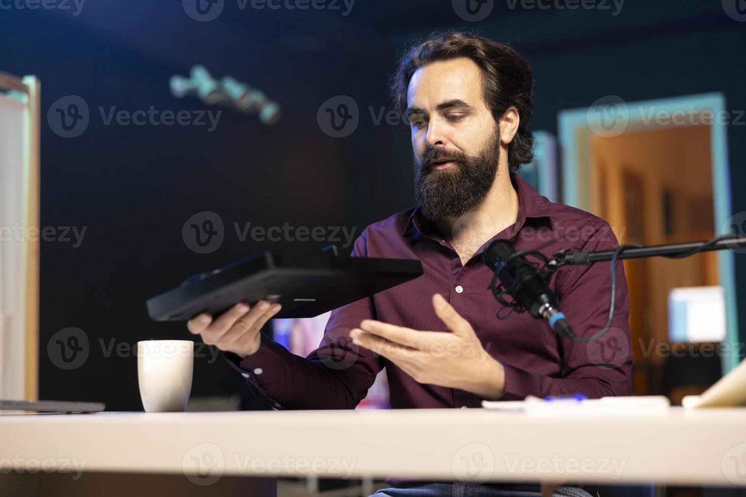 Content creator filming technology review of newly released DJ controller, unboxing it and presenting specifications to audience. Influencer showing sound mixer equipment to followers photo
