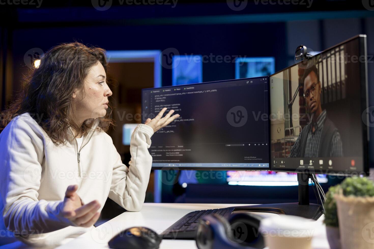 Software technician teacher doing online tutoring, talking with student in online videocall about ways to do debugging. IT master teaching apprentice woman in webinar how to write code photo