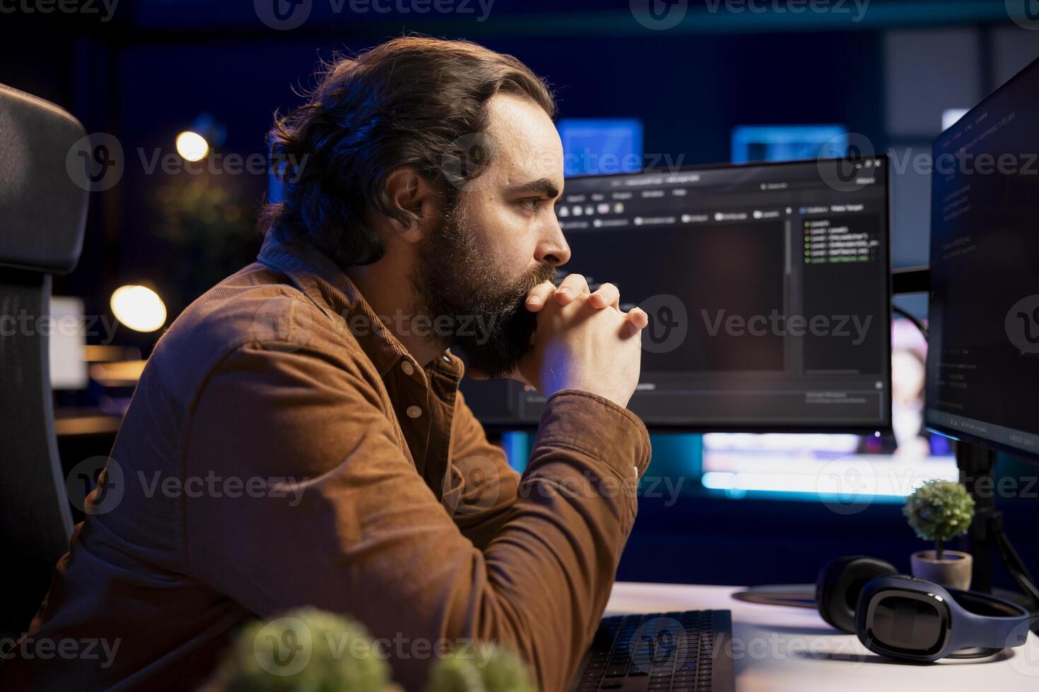 Pensive computer engineer thinking how to futureproof company network from downtimes and unexpected system failures. IT admin brainstorming ways to increase data security photo