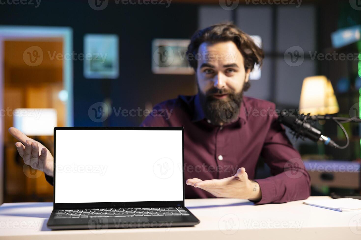 Portrait of tech specialist assessing mockup laptop performance, talking about parts used inside. Entertainer reviewing isolated screen notebook on technology internet channel photo