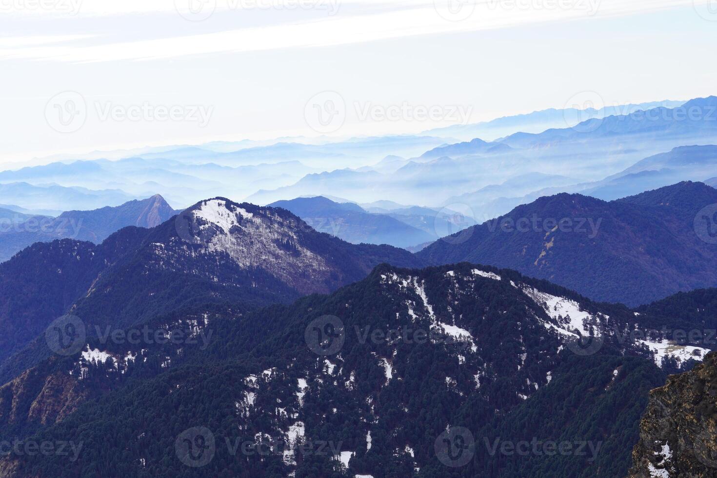A person standing on top of a mountain photo
