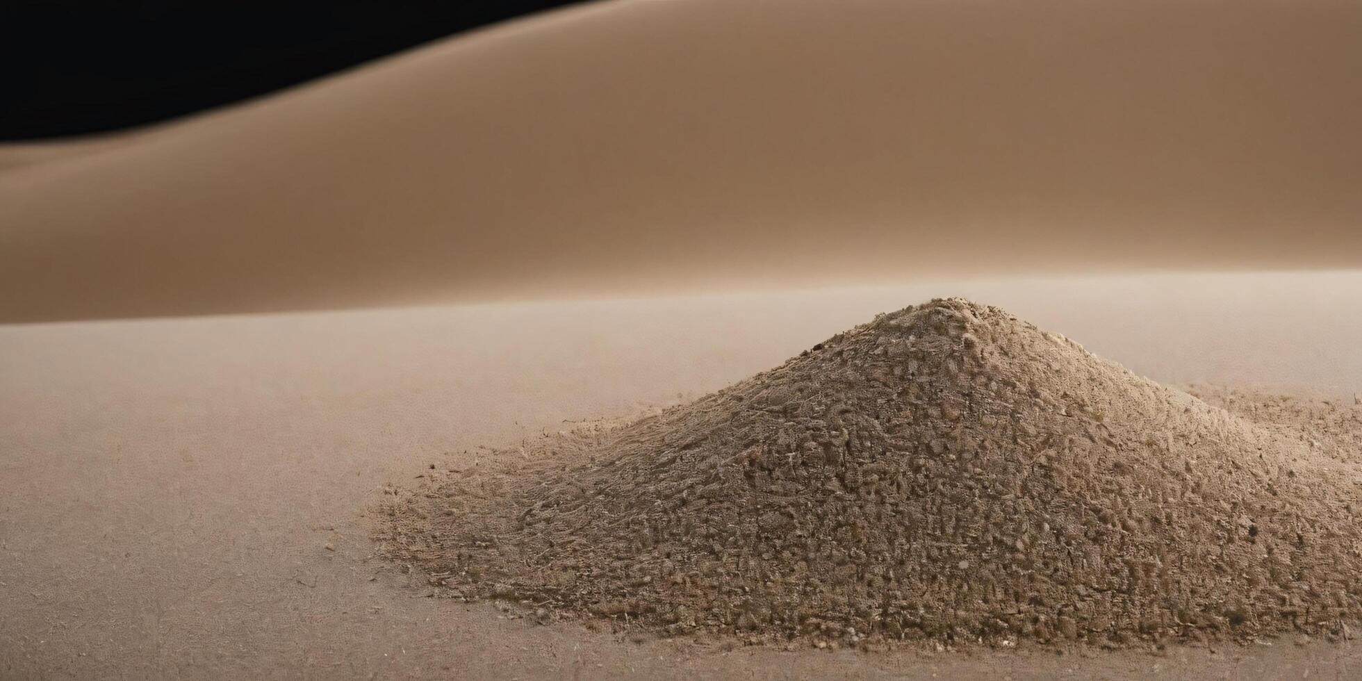 Small pile of sand against a desert dune backdrop. photo