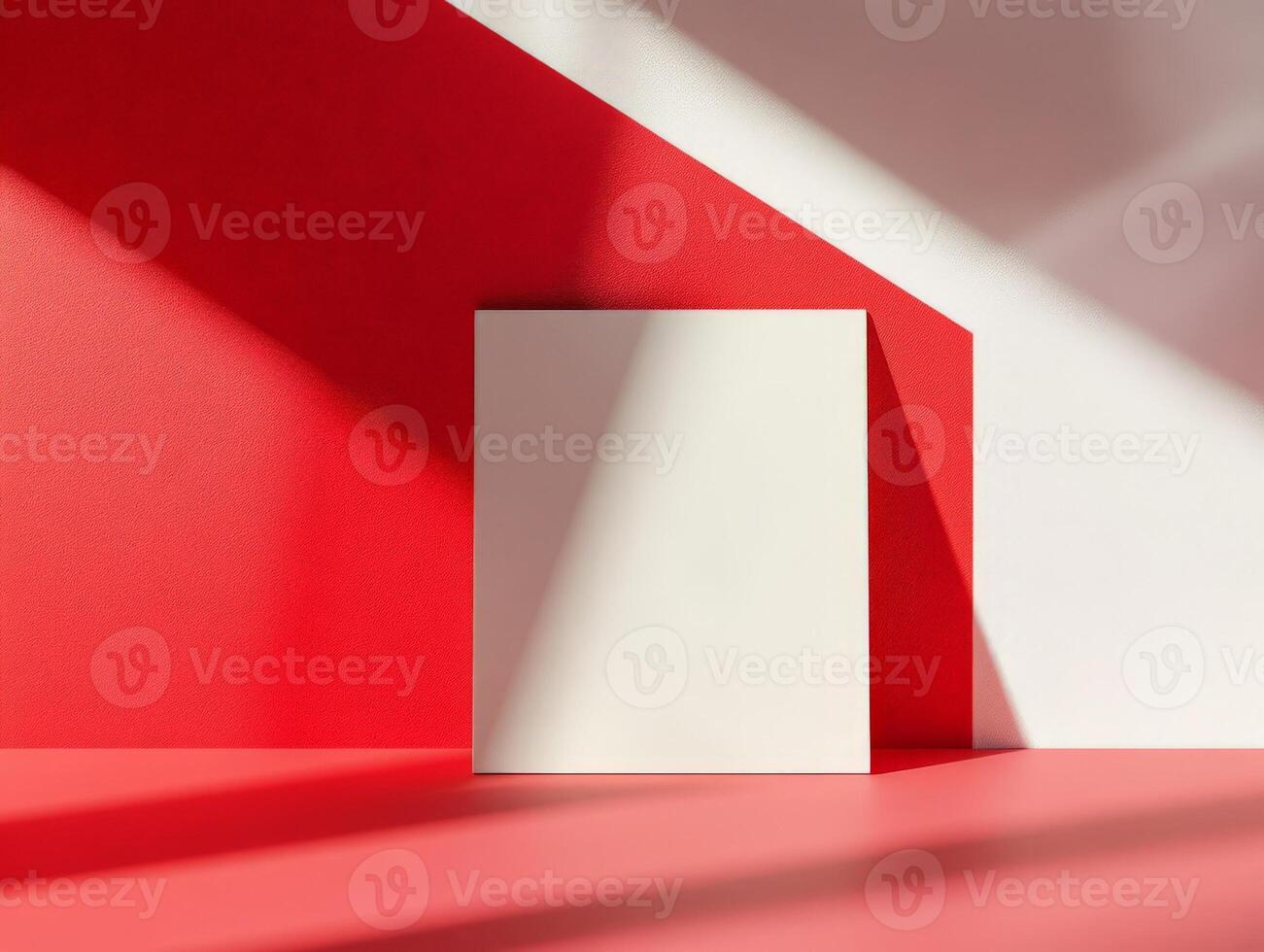 A minimalist composition featuring a blank white canvas against a red backdrop. photo