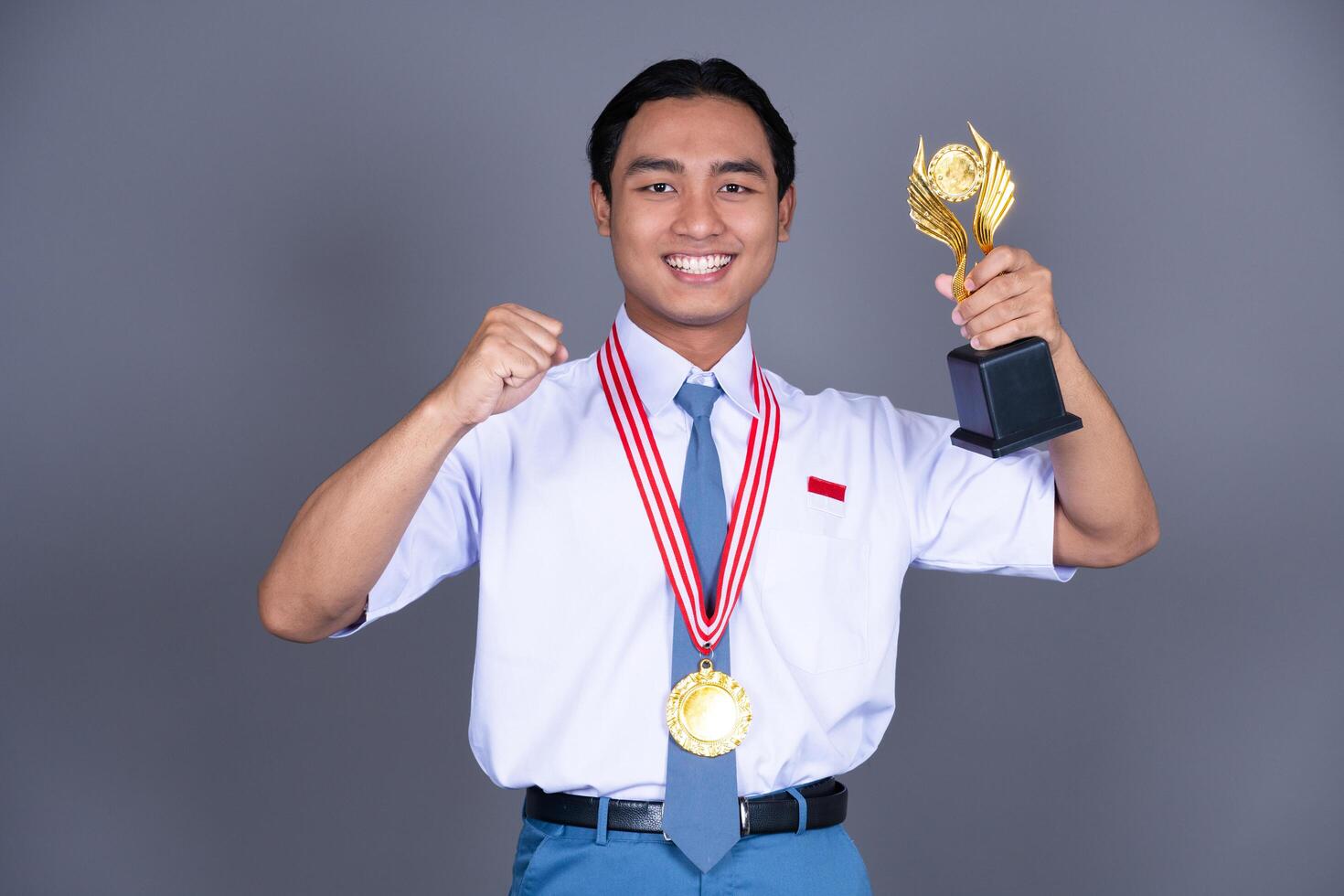 Indonesian Male High School in Uniform Student Achieves Gold Medal Isolated Background photo