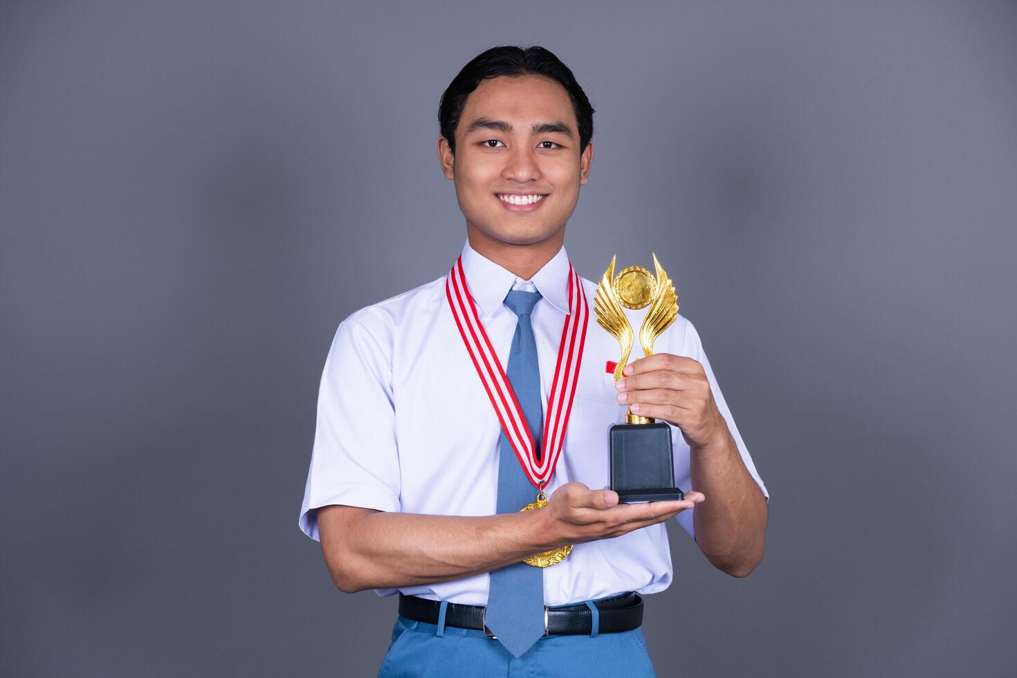 Indonesian Male High School in Uniform Student Achieves Gold Medal Background photo