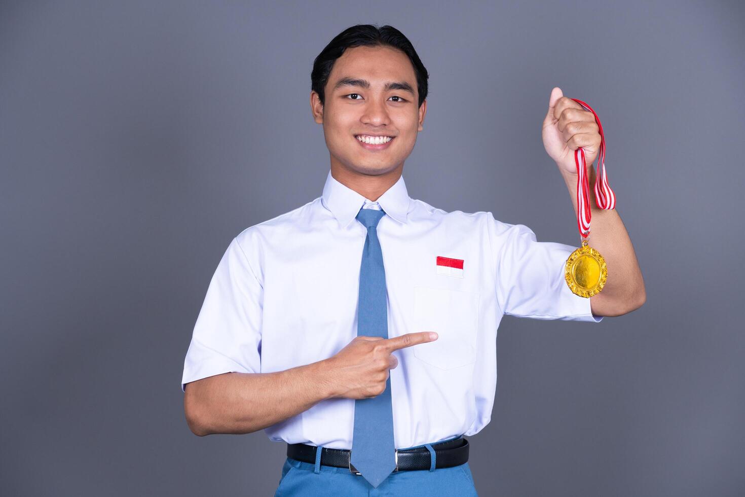 Indonesian Male High School in Uniform Student Achieves Gold Medal photo