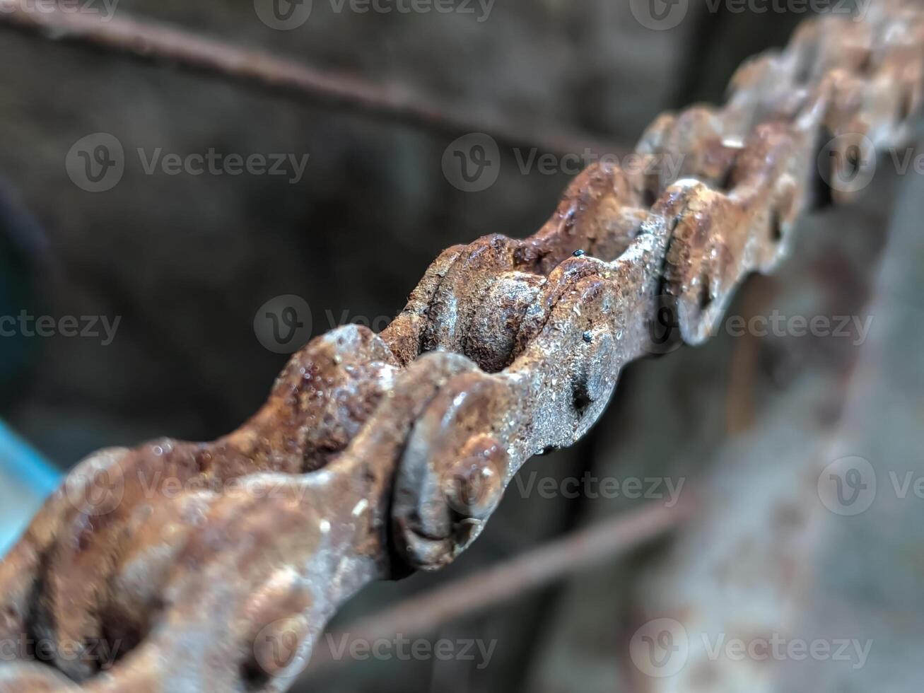A detailed close-up of a rusty chain, showcasing the rich textures and colors of corrosion. photo