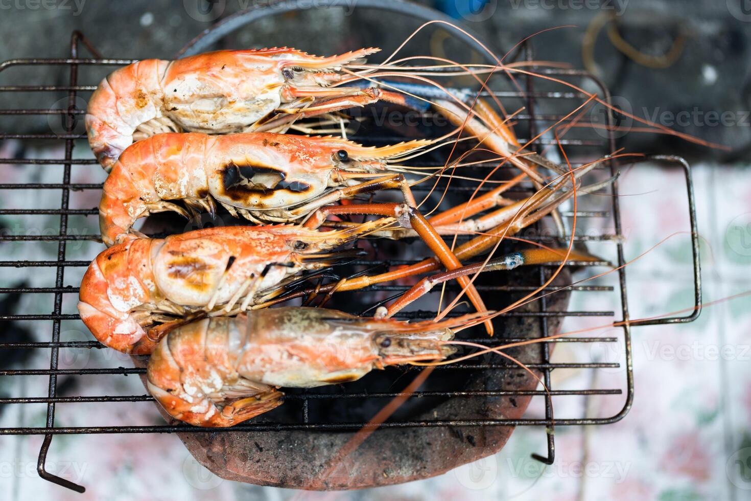 Fresh river prawns grilled over charcoal firez photo
