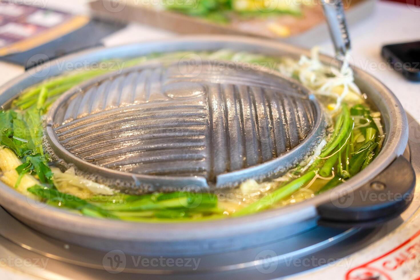 Barbecue hot pan prepare cooking Moo Kra Ta with boiled vegetable in hot pot photo