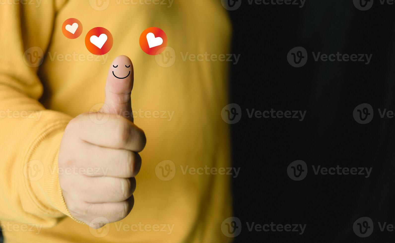 Man and show happy smiley face on thumb up with red heart emotion. Client satisfaction surveys and review. photo
