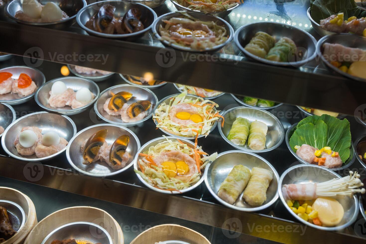 Many kind of dim sum in showcase at restaurant photo