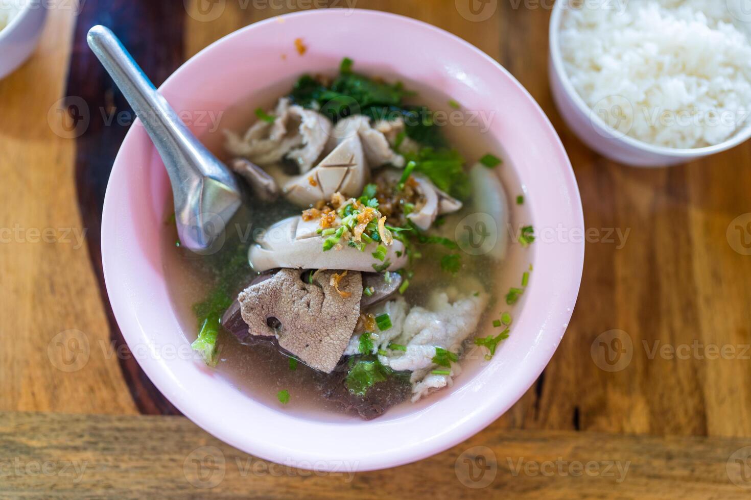 Thai style boiled clear soup with pork entrails pork blood cubes and liver in bowl. Healthy and rich in iron and protein photo