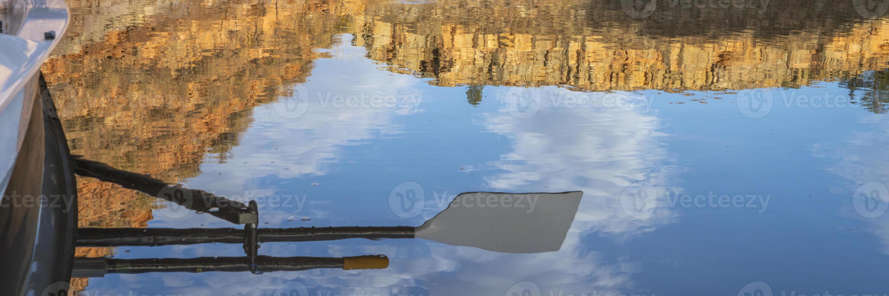 water reflection of oars of coastal sculling shell in sandstone canyon of Horsetooth Reservoir in Colorado in fall scenery photo