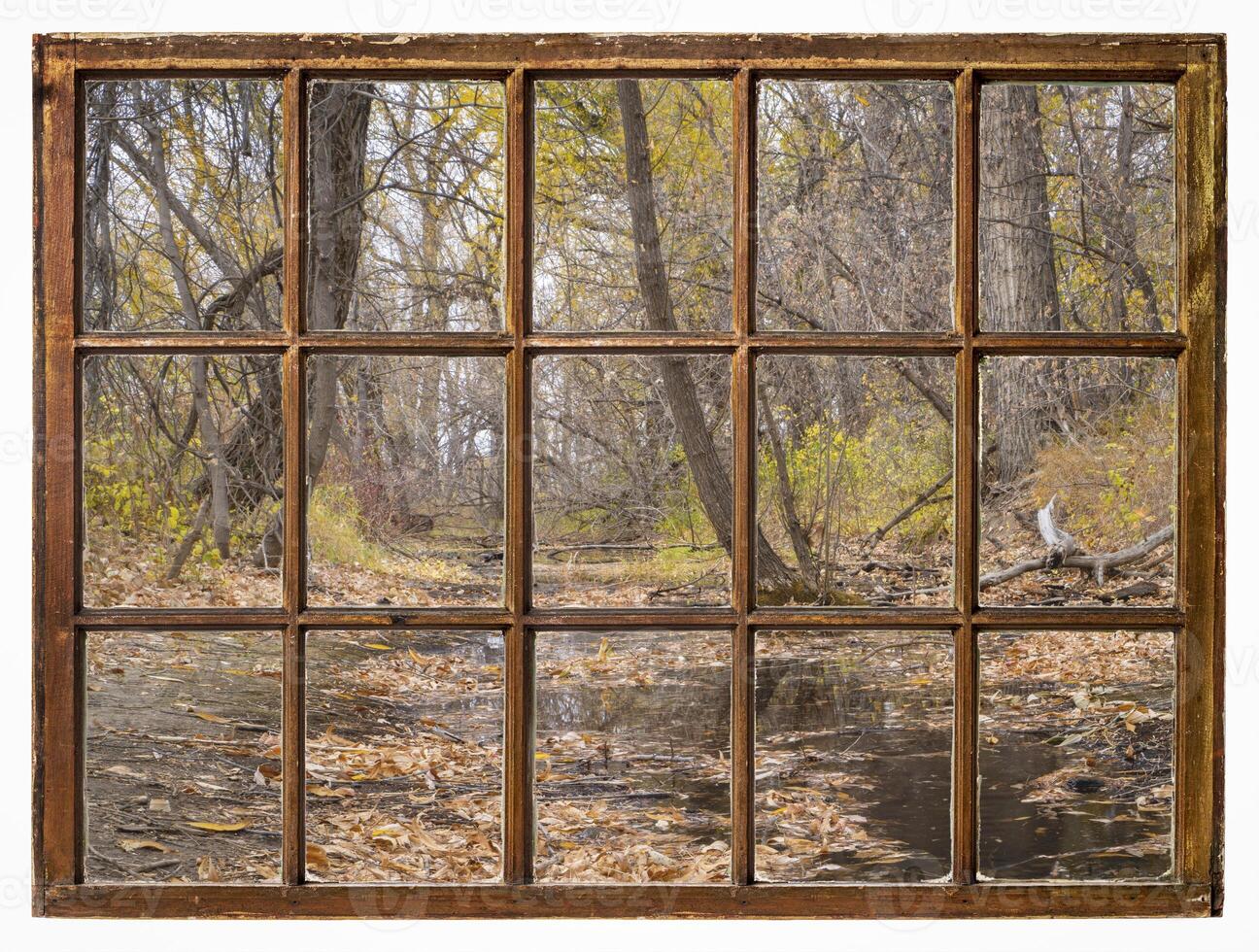 nostalgic fall landscape along a river, view from a vintage window photo