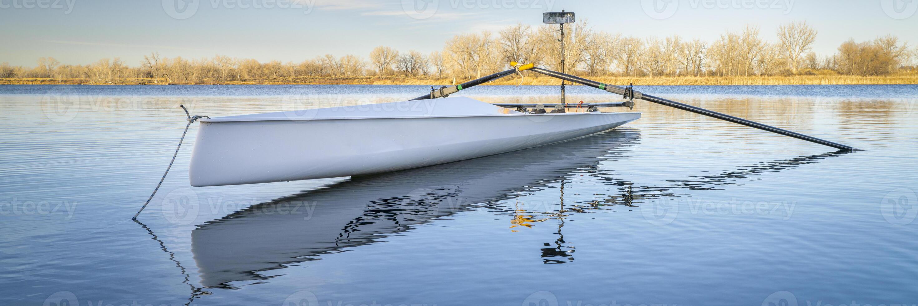 rowing shell by on a lake in northern Colorado in winter or early spring scenery. photo