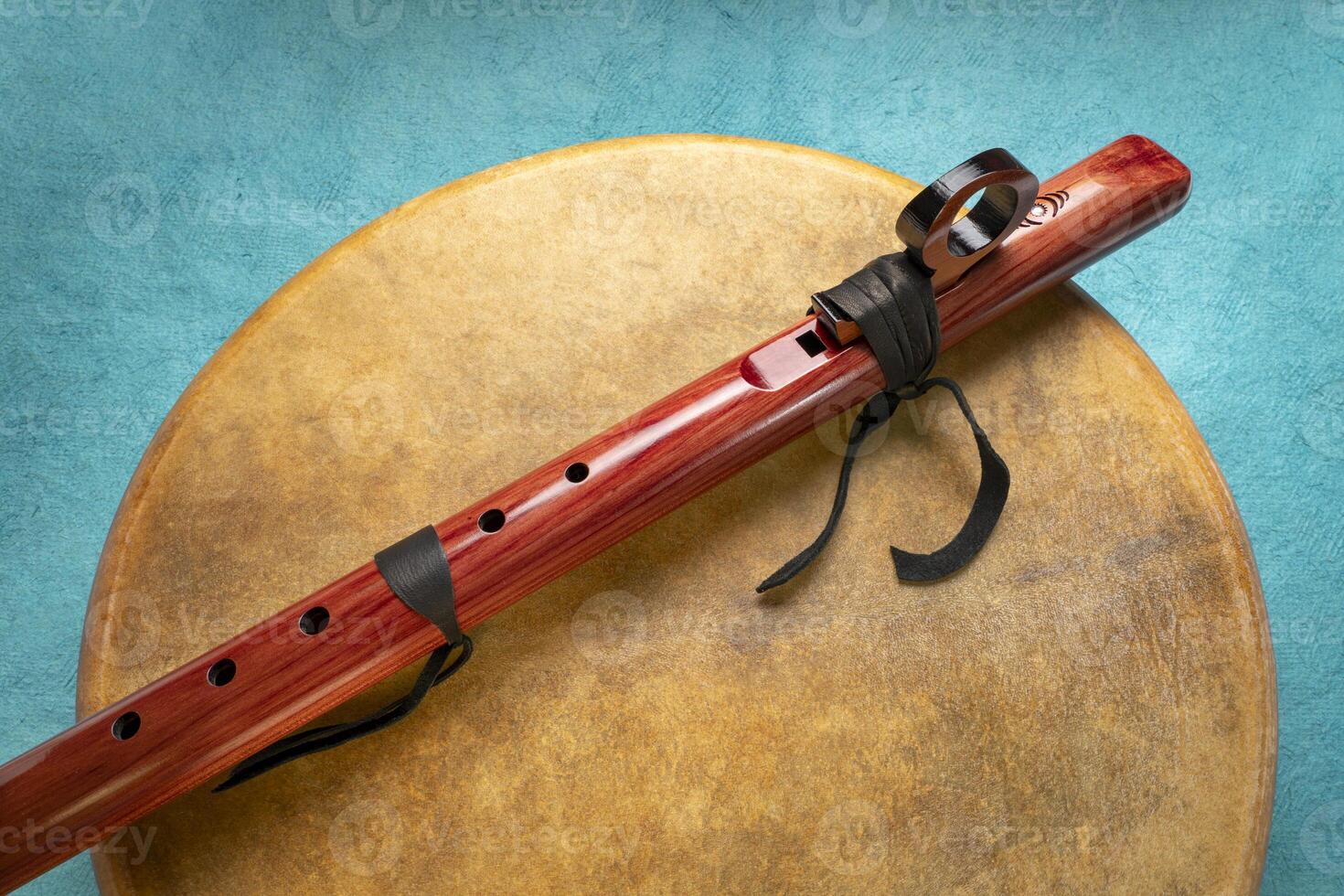 native American style flute handcrafted from aromatic cedar and shaman drum coverd by gout skin photo