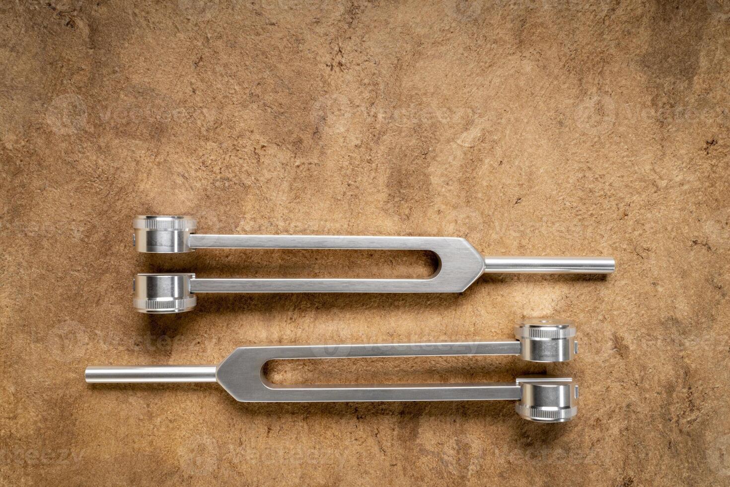 weighted metal tuning forks used for tuning musical instruments, sound therapy, chakra healing or relaxation photo
