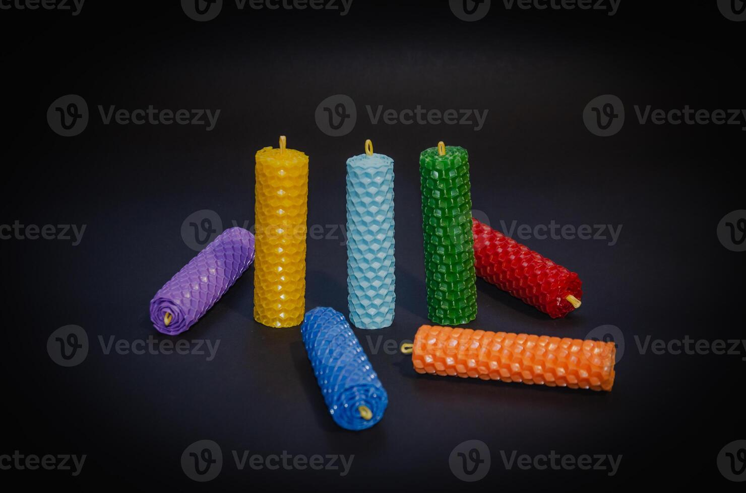 Candles of different colors on a black background, chakra candles. High quality photo
