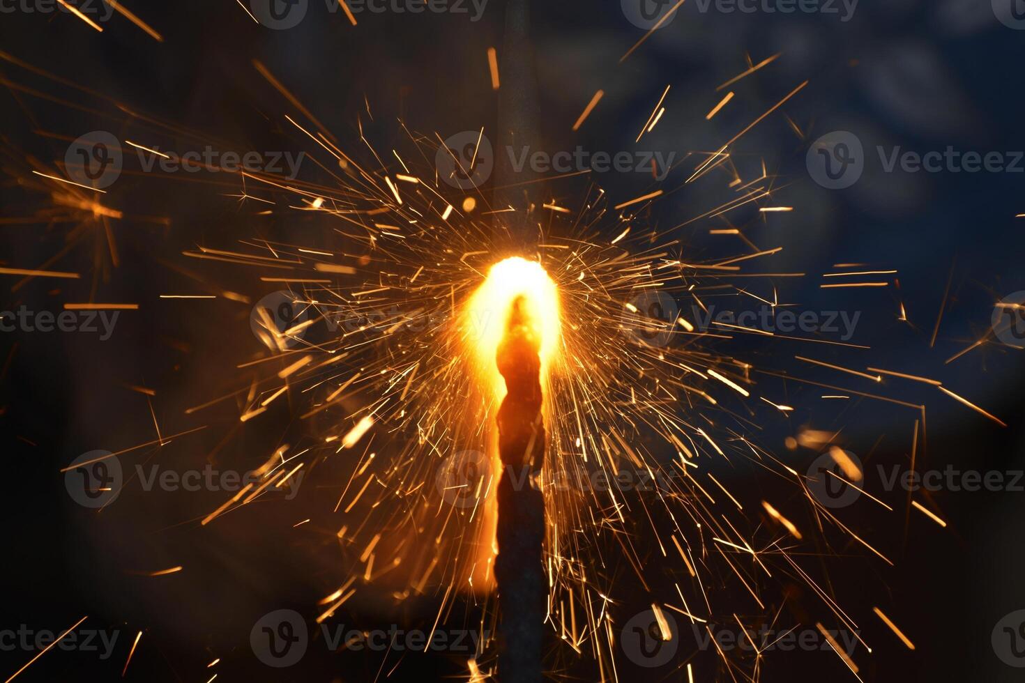 A sparkler is lit with a flame photo
