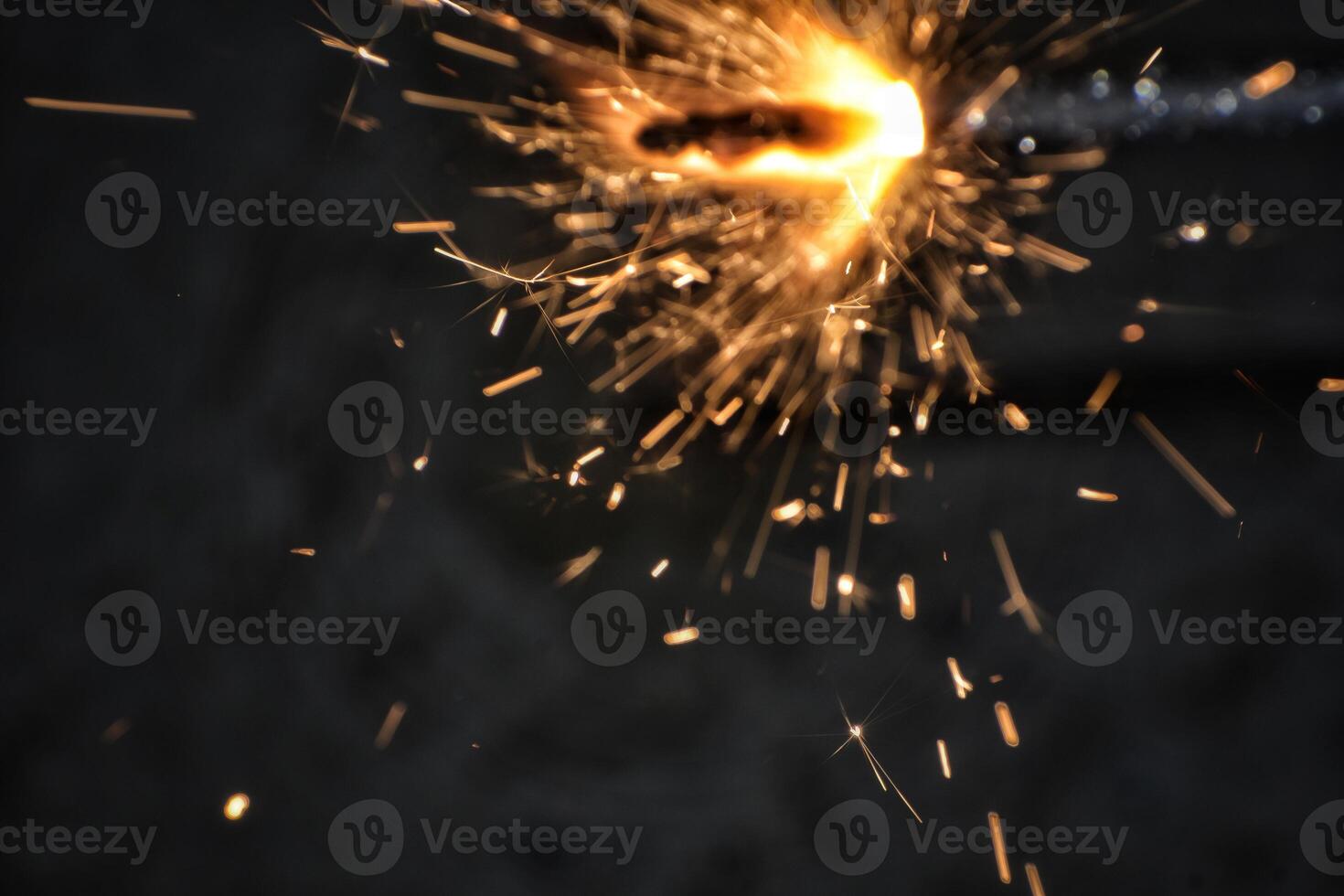 A sparkler is lit on a black background photo