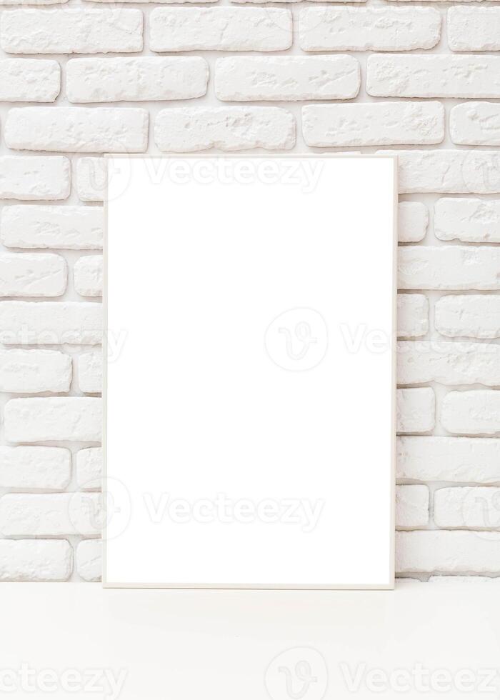 Blank art canvas leaning against a rustic white brick wall indoors during daylight, perfect for creative expression and design photo