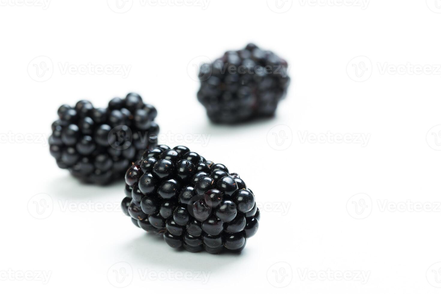 Fresh blackberries arranged on a clean white surface ready for consumption or culinary use at any time photo