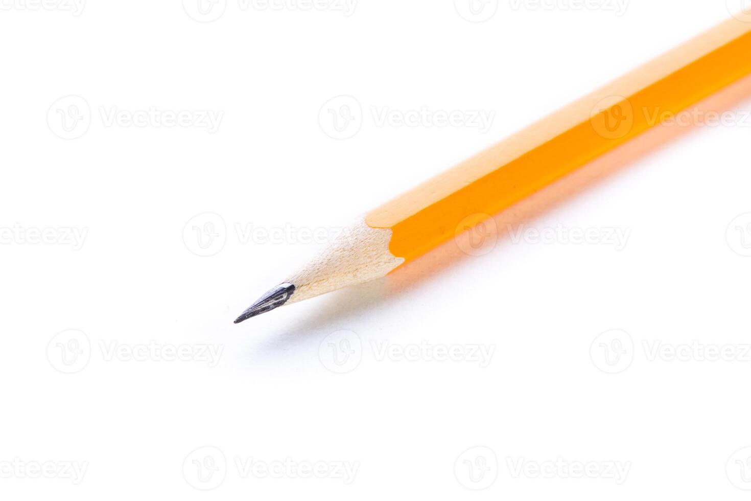 Close-up of a sharpened yellow pencil resting on a white surface capturing the essence of creativity and study photo